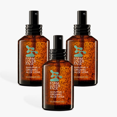Drei bernsteinfarbene Pumpflaschen mit Farm Loves Face AHA/PHA + Bio-Aloe Vera Reinigungsgel sind auf weißem Untergrund angeordnet. Die Flaschen haben grün-weiße Etiketten mit Blattmotiv.