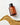 Eine braune Farm Loves Face-Flasche mit der Aufschrift "Veganes Kollagen + Bio-Hafer Barriere & Hydro Toner + Gratis Socken" ruht auf einer weißen Fläche neben einer geschwungenen Linie aus Haferkörnern - ideal für deine Hautbarriere.