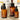 Drei Braunglasflaschen mit Hautpflegeprodukten von „Farm Loves Face“, darunter eine Hydrocreme und Hydrotoner, sind mit minimalistischen Etiketten und moderner Verpackung vor ihren Kartons auf einer hellen Oberfläche angeordnet.